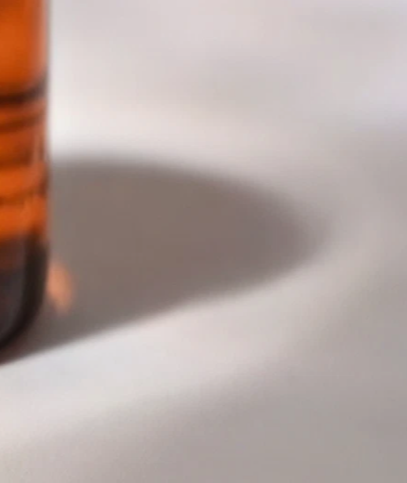 The base of the Aivee Glass Mist vial among out-of-focus ampoules