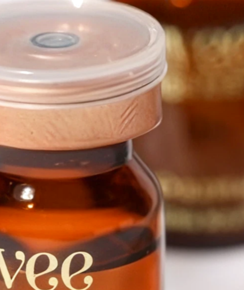 The upper body and copper cap of the Hydrating Hyaluronic Serum vial
