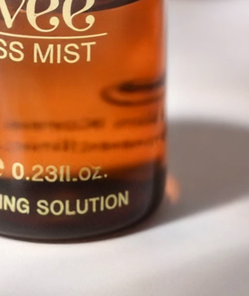 The base of the Hydrating Hyaluronic Serum vial on its cream backdrop