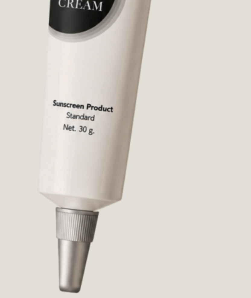 The lower body and nozzle of the Tinted Sunscreen SPF30 tube on its cream backdrop